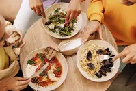 friends eating meal at restaurant
